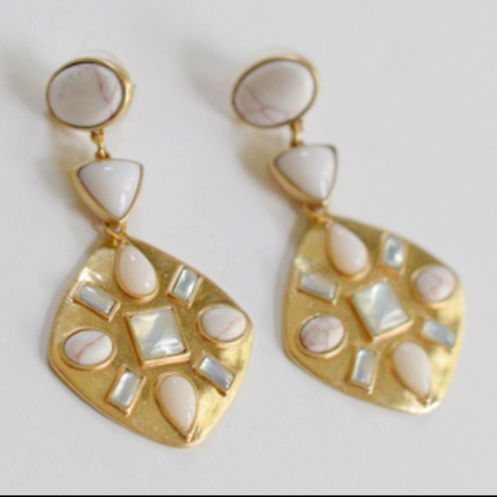 Gold earrings with white stone-looking details